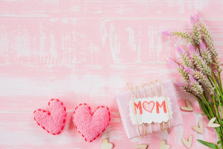 Happy mother's day concept on pastel color bright pink and white wooden background.