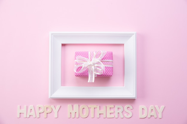 Happy mother's day concept. Top view of picture frame and gift box 