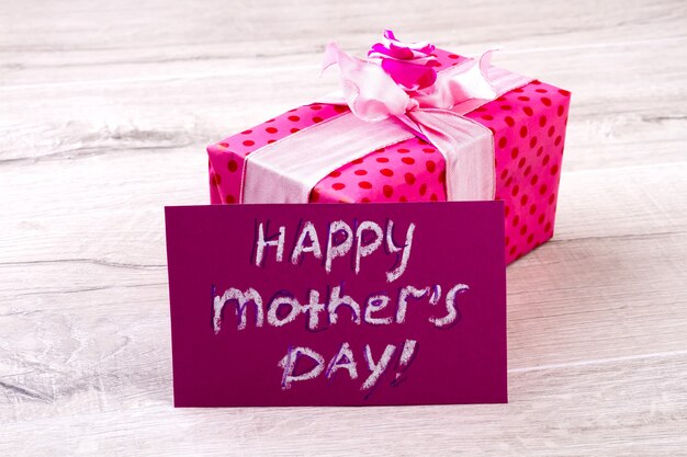 Photo happy mother's day gift. greeting card aside pink box. creativity without borders. nice gift for precious woman.