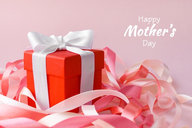 Happy Mother's Day or women's day Valentine's day Red box with a gift in festive ribbons