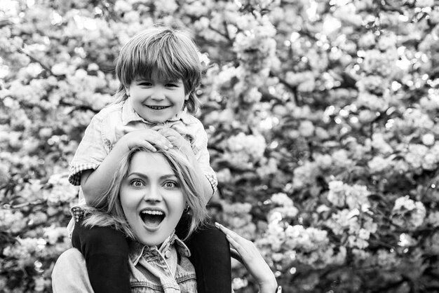 Happy mother and son cute child hugging his mother