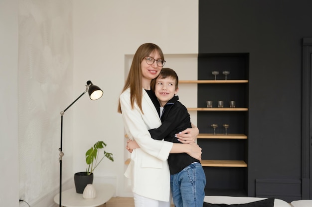 Happy mother and son in the interior of the living room.