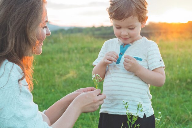 Happy mother and son on nature on sunset