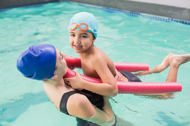 Happy mother and son in the swimming pool