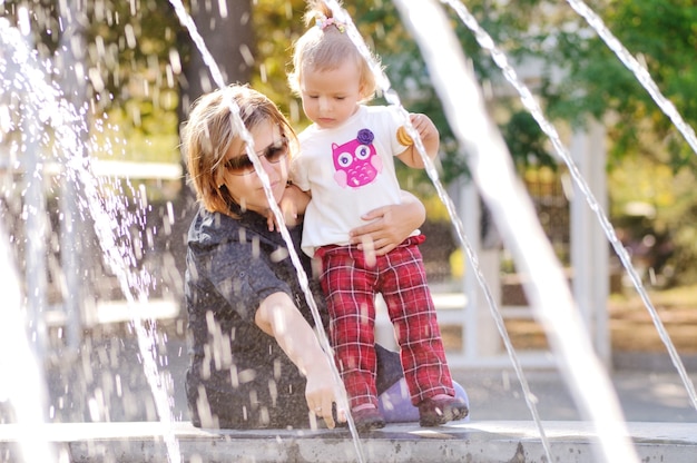 写真 fontainの近くの女の赤ちゃんと幸せな母