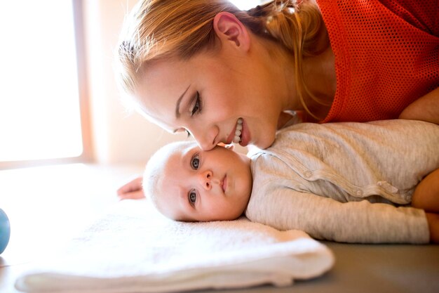 Happy mother with baby at home