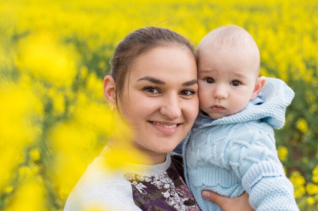 Happy mother with the child in the field