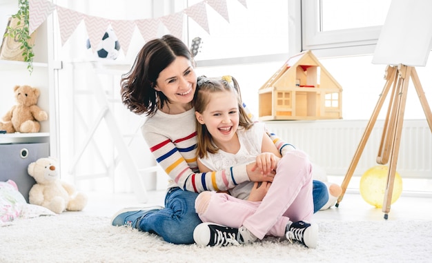 Happy mother with daughter having fun