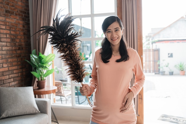 Happy mother with feather duster