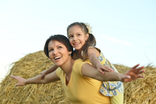 Happy mother with her daughter on the field