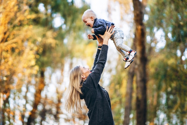 Madre felice con il suo piccolo figlio del bambino che si diverte nel parco