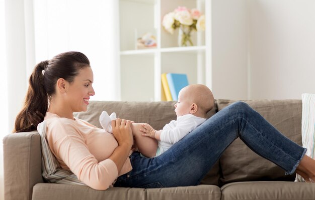 happy mother with little baby boy at home