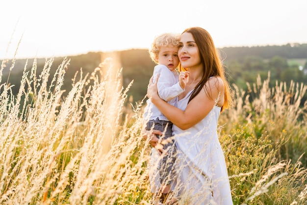 Happy mother with little son in arms