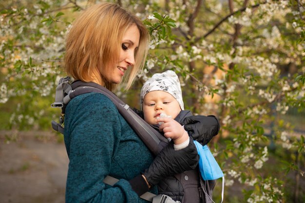 Happy mother in with little son playing in the park