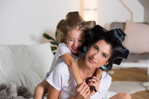 happy mother and young daughter at home. Happy family people concept.mother and kid hugging, smiling.