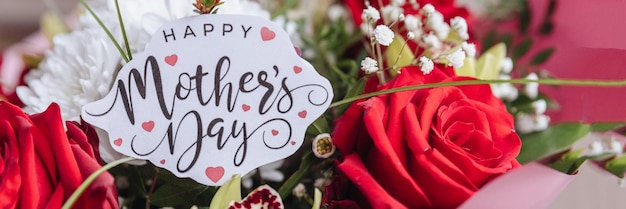 Happy Mothers Day text on gift card with flower bouquet of roses orchids chrysanthemums Greeting card for Mom Flower delivery Congratulations surprise for mother