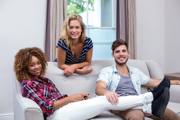 Happy multi ethnic friends relaxing at sofa