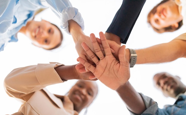 Happy multiethnic young friends holding hands together