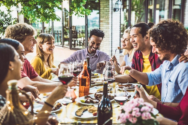 Happy multiracial family having bbq dinner party outside