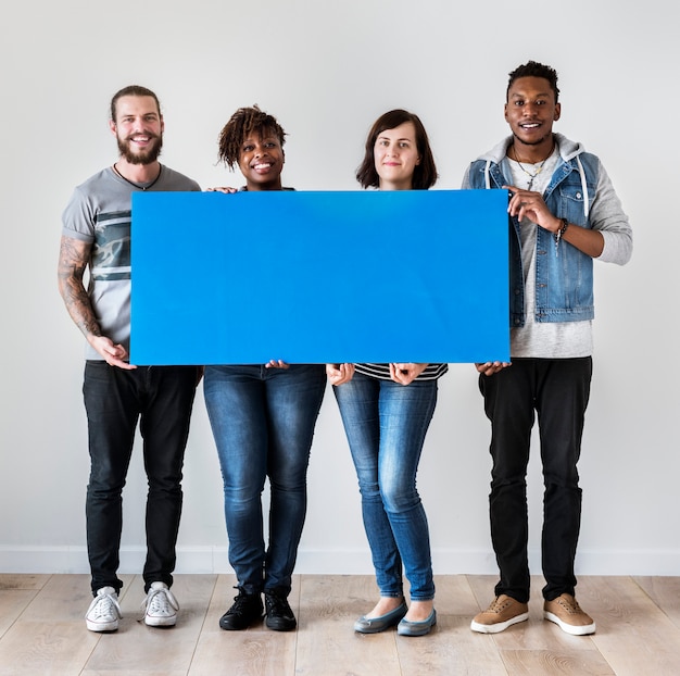 Happy multiracial people holding copyspace speech bubble