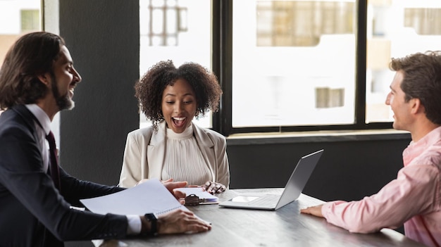 happy multiracial team coworkers have meeting at office