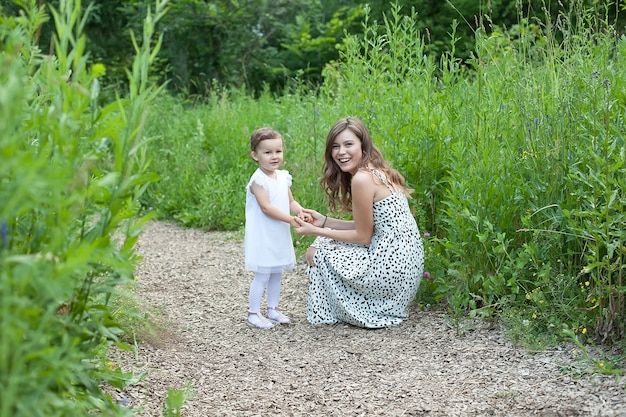 Happy mum and her child playing in park together