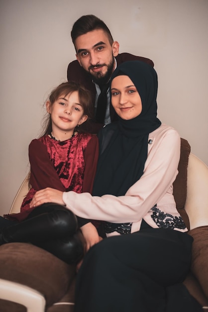 Happy Muslim Family Portrait Smiling parents and their cute little daughter posing together