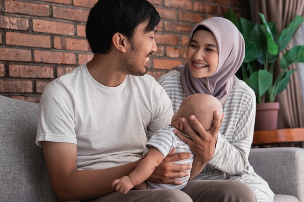 Happy Muslim family with a cute baby