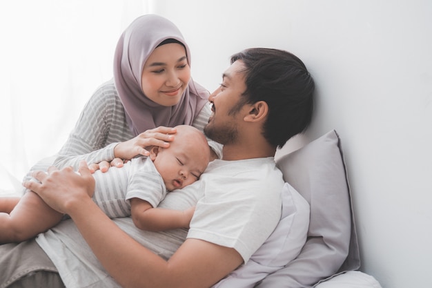 Happy Muslim family with a cute baby