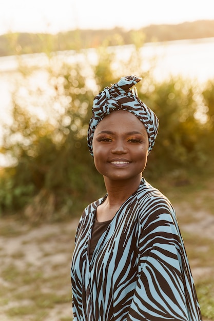 Happy muslim girl close up in trendy traditional clothes smiles