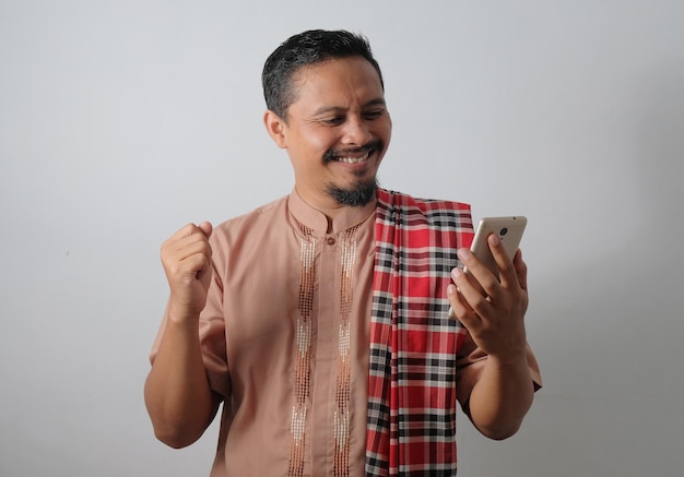 Happy muslim man carrying phone in hand