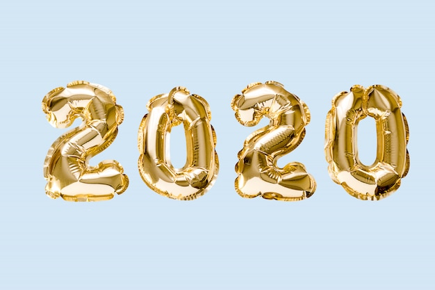 Happy New year 2020 celebration. Gold foil balloons numeral 2020 isolated on blue background