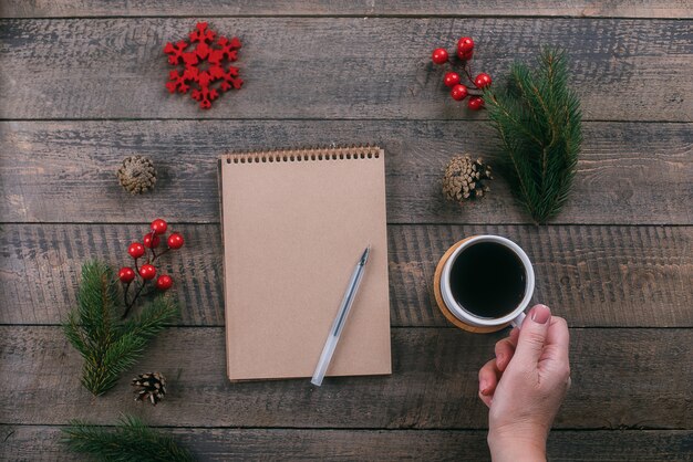 Happy New Year 2020 and Christmas concept. Woman's hand holding cup of coffee