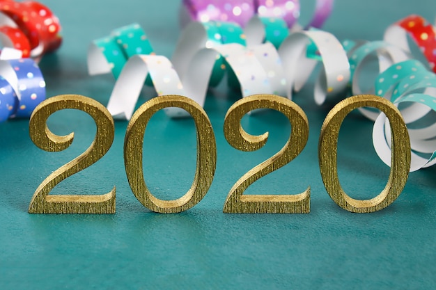 Happy New Year 2020. Creative text Happy New Year 2020 written in gold wooden letters.