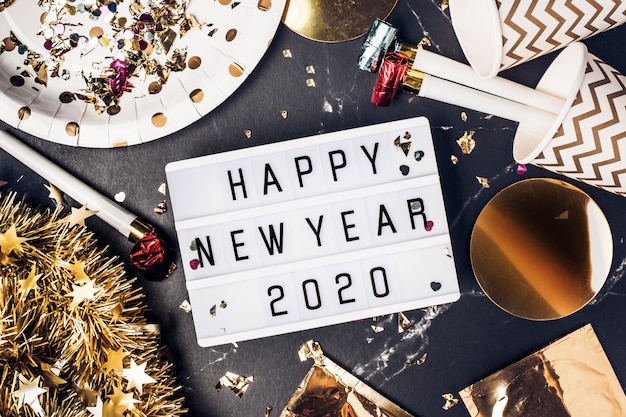 Happy new year 2020 on light box with party cup