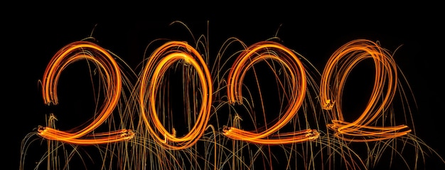 Photo happy new year 2022 sparkling burning text happy new year 2022 isolated on black background