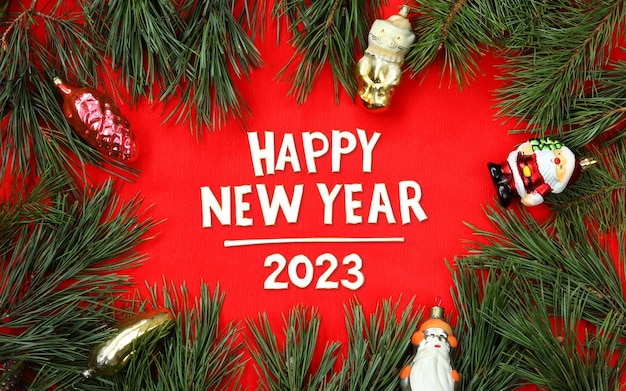 Happy New Year 2023 christmas composition on red background Fir branches