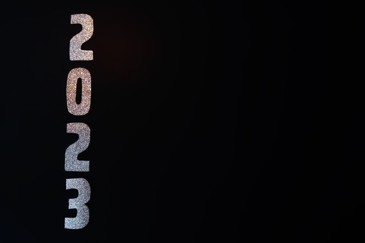 Photo happy new year 2023 golden numbers on a black background with glitter