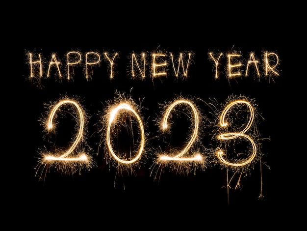 Happy New Year 2023. Sparkling burning text Happy New Year 2023 isolated on black background. Beauti