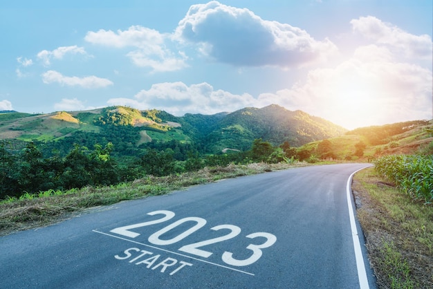 Happy new year 20232023 symbolizes the start of the new year The letter start new year 2023 on the road in nature route roadway sunrise have tree environment ecology or greenery wallpaper concept