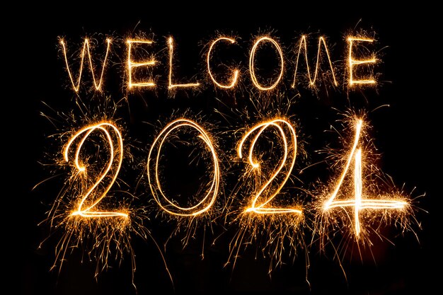 Happy New Year 2024 Sparkling burning text Happy New Year 2024 isolated on black background