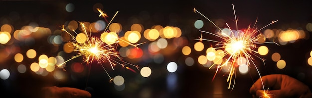 Happy New Year background with glowing sparklers.