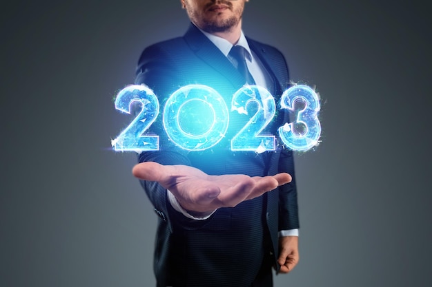 Happy new year businessman points to the number 2023 Magazine style banner website header web poster