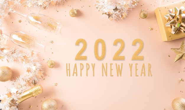 Happy New year celebration background concept. Golden gift box, stars, christmas ball and champagne on pastel background.