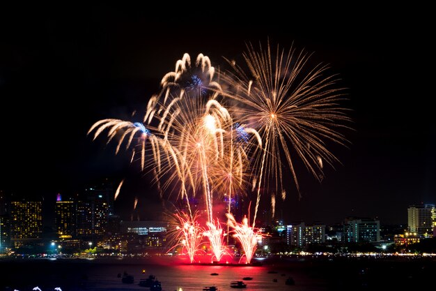 Happy new year fireworks over cityscape at night. holiday celebration festival