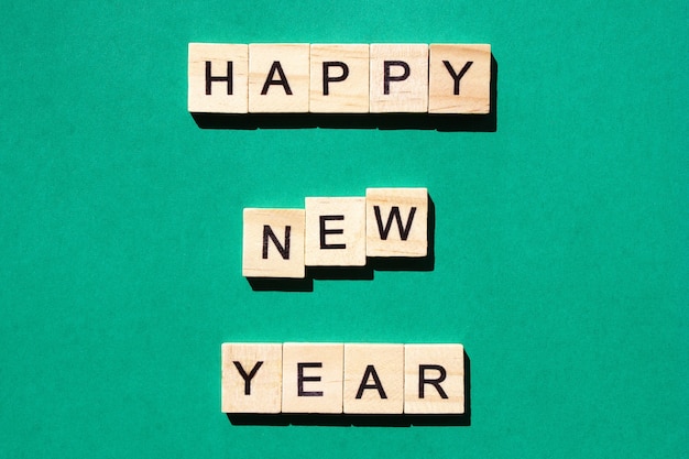 Happy New Year - an inscription made in black letters on wooden blocks