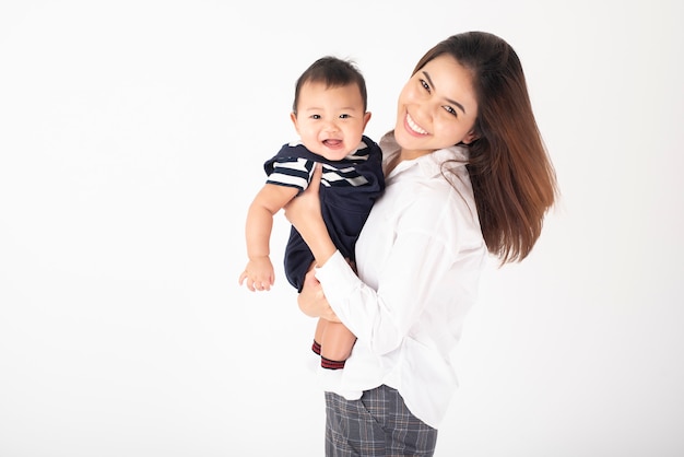 Happy newborn cute baby and beautiful mom in studio