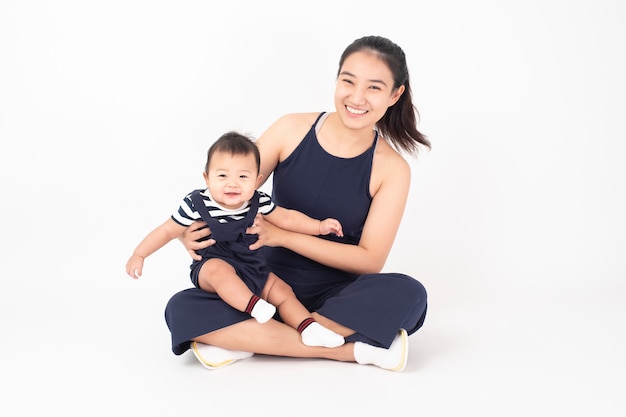 Happy newborn cute baby and beautiful mom in studio