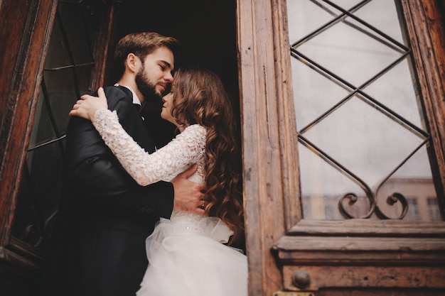 Happy newlywed couple hugging and kissing