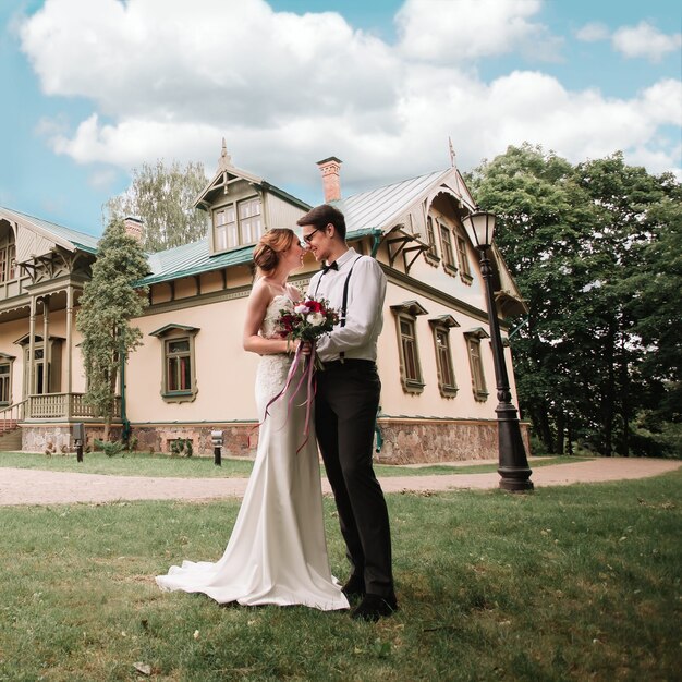 Happy newlyweds near their new chic home